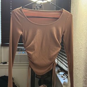 Light pink long sleeve shirt with string on both sides